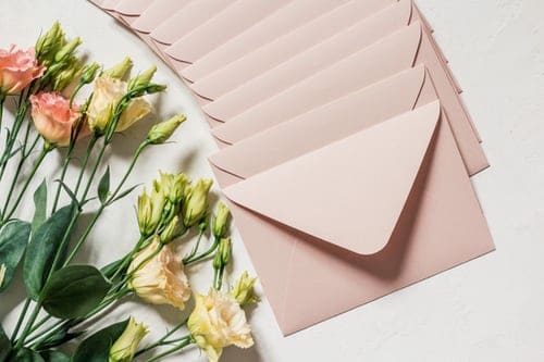 flowers and envelopes on white surface